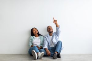 Dreaming african american couple planning interior, decorations and furniture in their own house